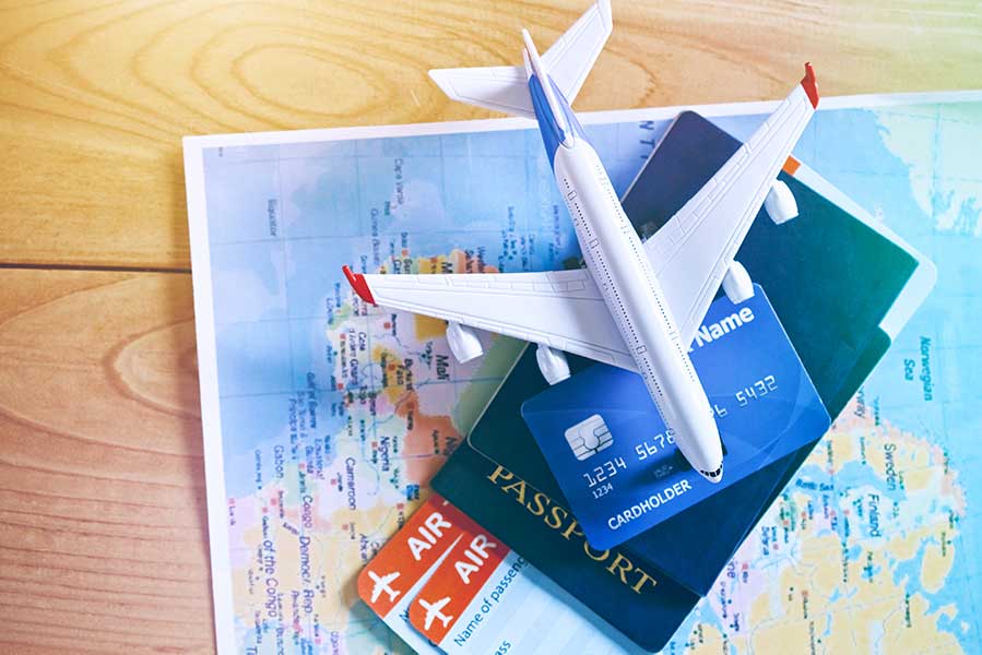 Air tickets, passports and credit card on world map