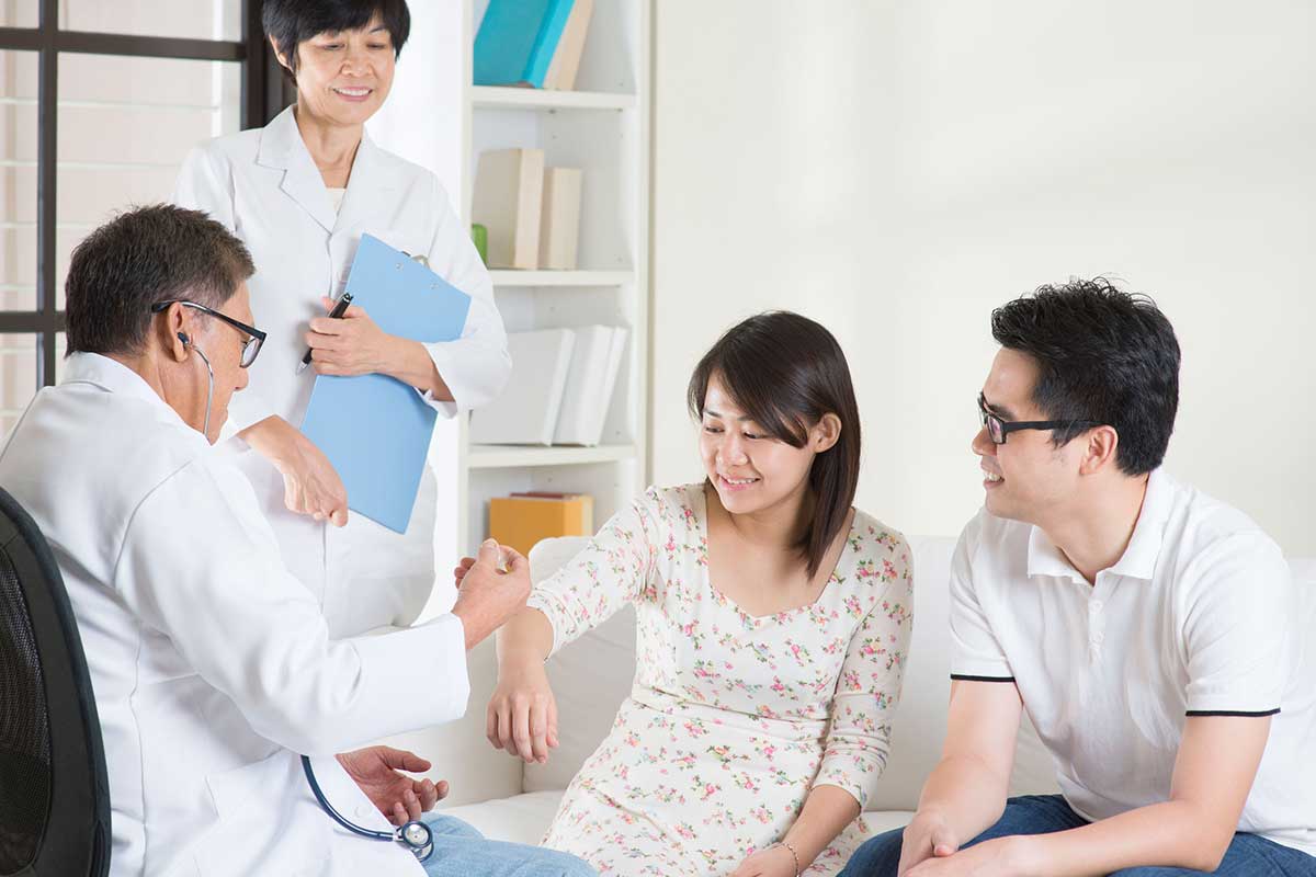Asian couple visiting a doctor for vaccination